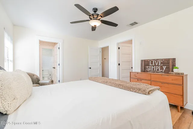 a bedroom with a bed and a large mirror