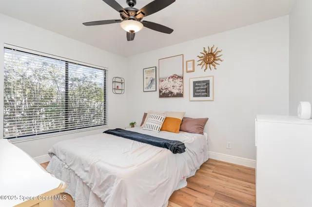 a bedroom with a large bed and a large window