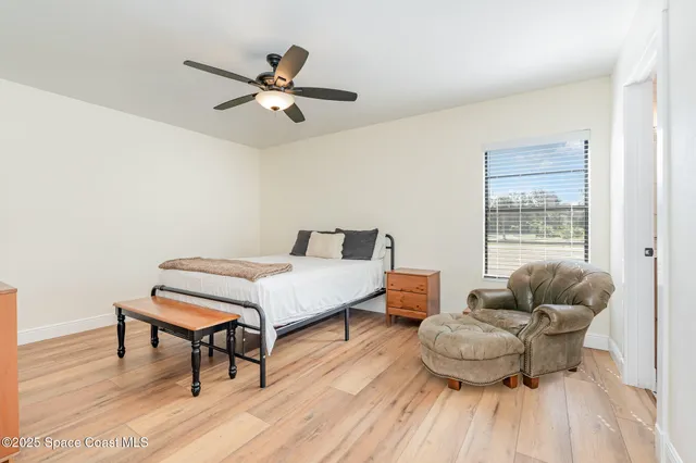 a bedroom with furniture and a wooden floor
