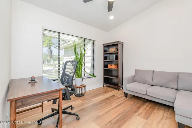 a view of a livingroom with workspace and a couch
