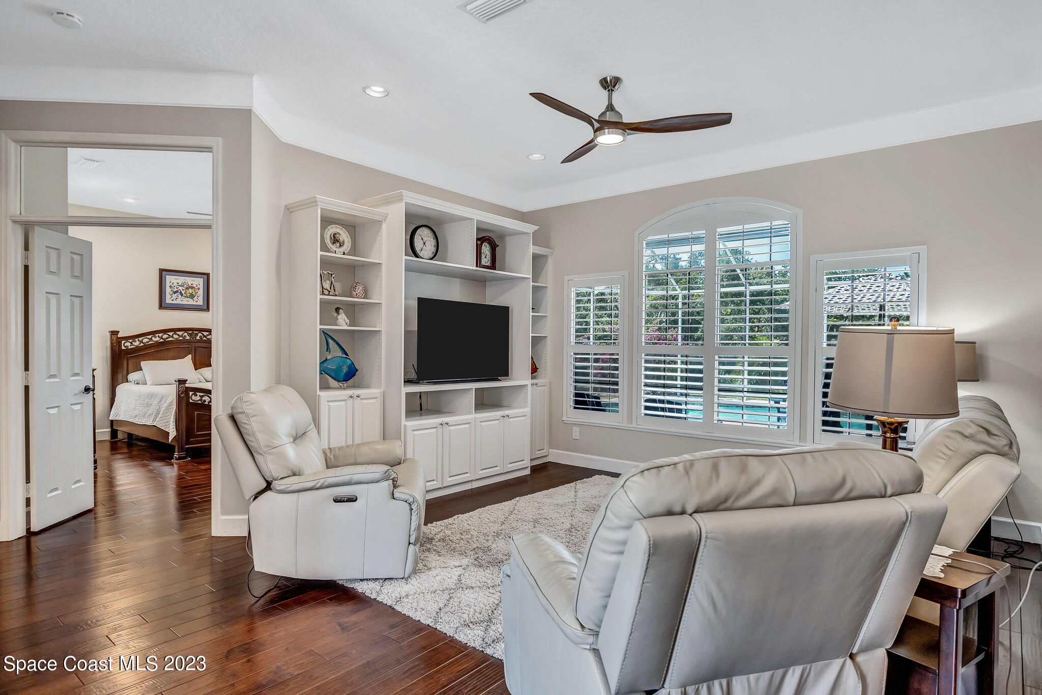 4320 Canard Road Melbourne, FL 32934 - Photo 22 of 78 a living room with furniture floor to ceiling window and a flat screen tv