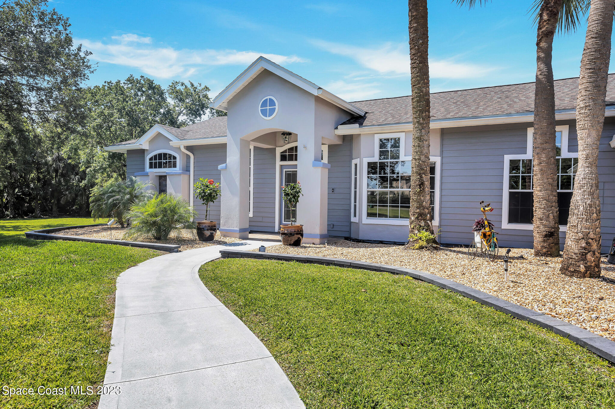 4320 Canard Road Melbourne, FL 32934 - Photo 3 of 78 a front view of a house with a yard
