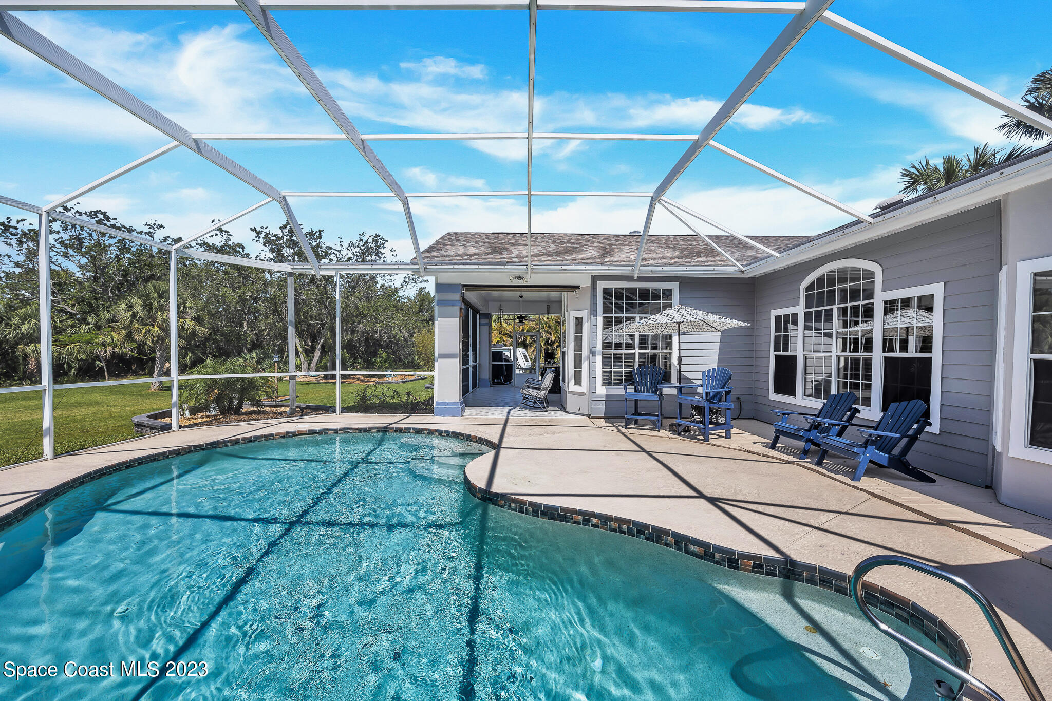 4320 Canard Road Melbourne, FL 32934 - Photo 57 of 78 a view of patio with a table and chairs under an umbrella