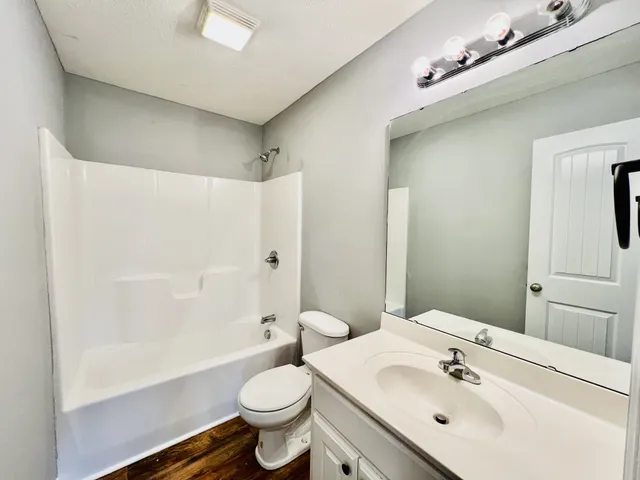 a bathroom with a sink mirror toilet and bathtub