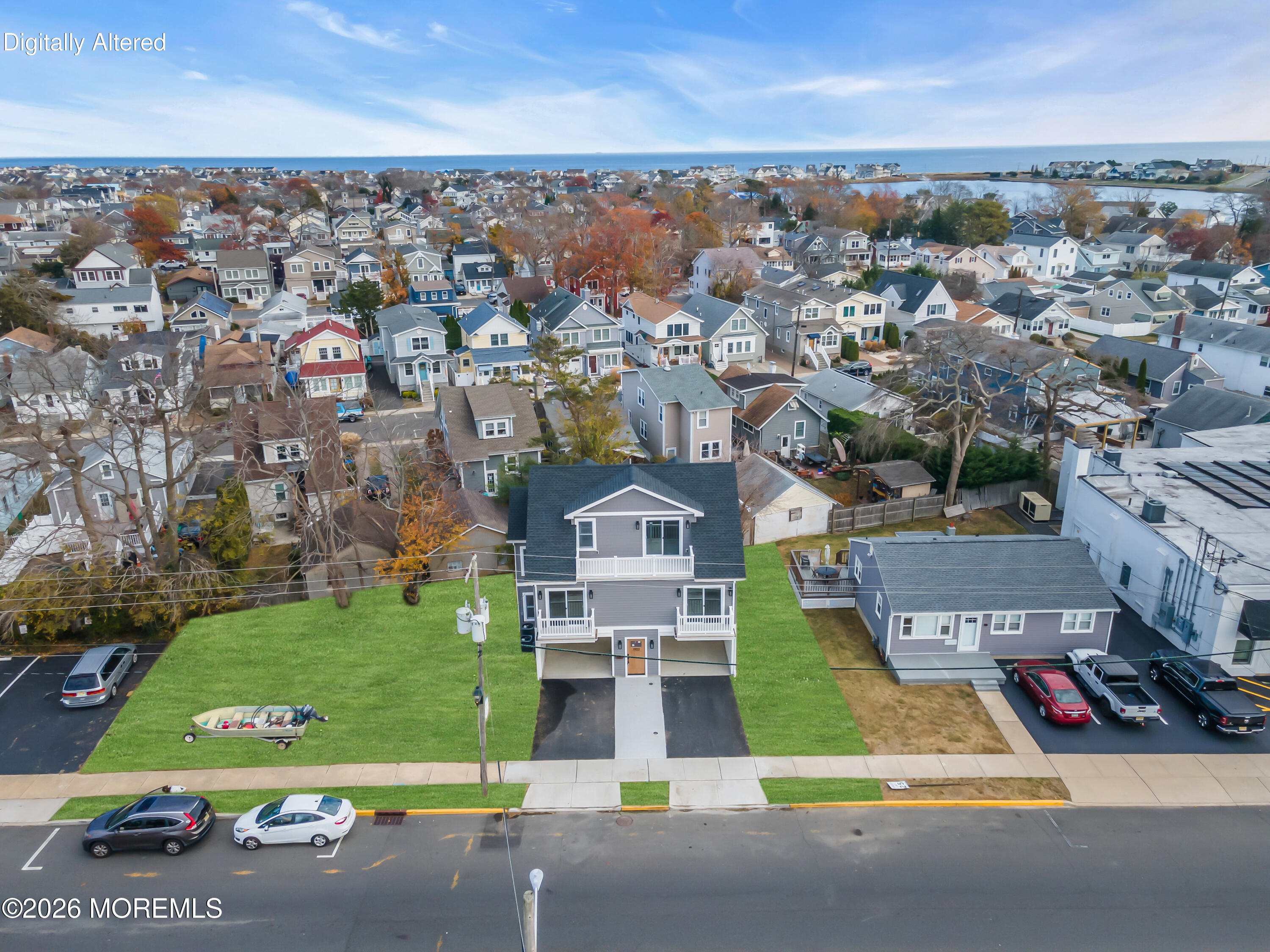 an aerial view of multiple houses with a yard