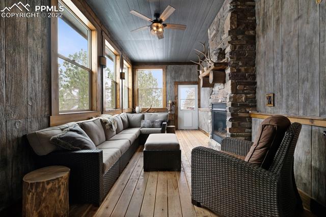 7750 Poco Road Colorado Springs, CO 80908 - Photo 14 of 20 3 season room/covered patio with gas fireplace
