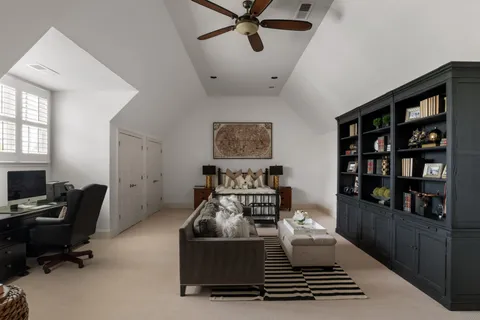 a bedroom with furniture and a book shelf