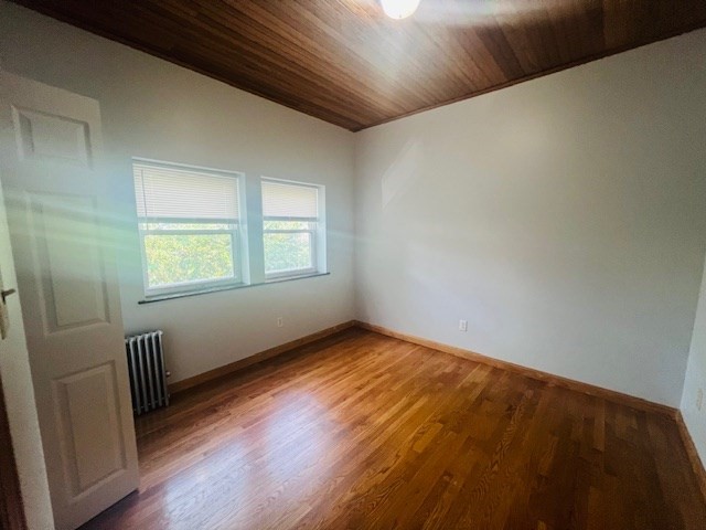 9 Rice Street, Unit 3 Brookline, MA 02445 - Photo 3 of 7 a view of an empty room with wooden floor and a window