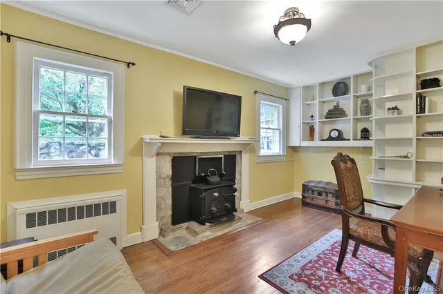 a livingroom with a fireplace and workspace