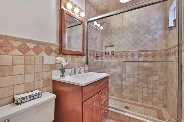 a bathroom with a sink toilet and shower