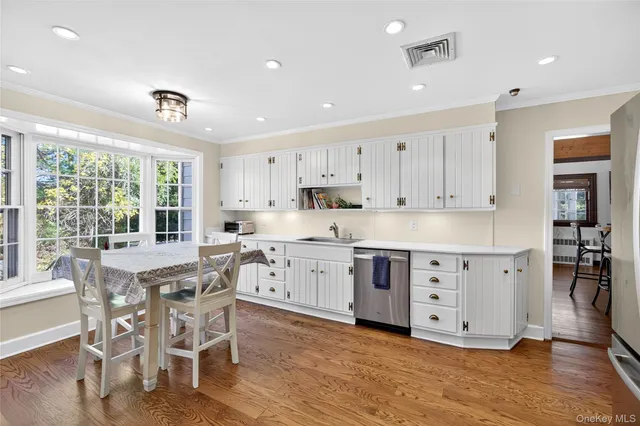 a kitchen with granite countertop a white stove top oven and cabinets