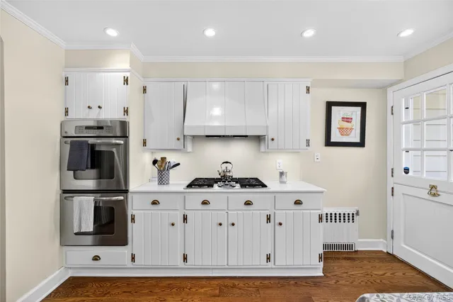 a kitchen with stainless steel appliances granite countertop a refrigerator and a stove