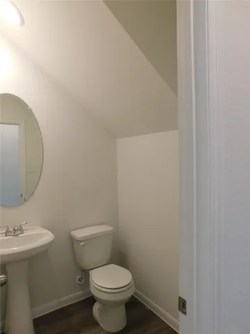 a white toilet sitting next to a bathroom sink