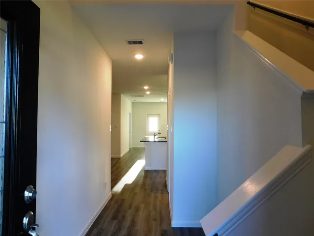 a view of a hallway with a wooden floor