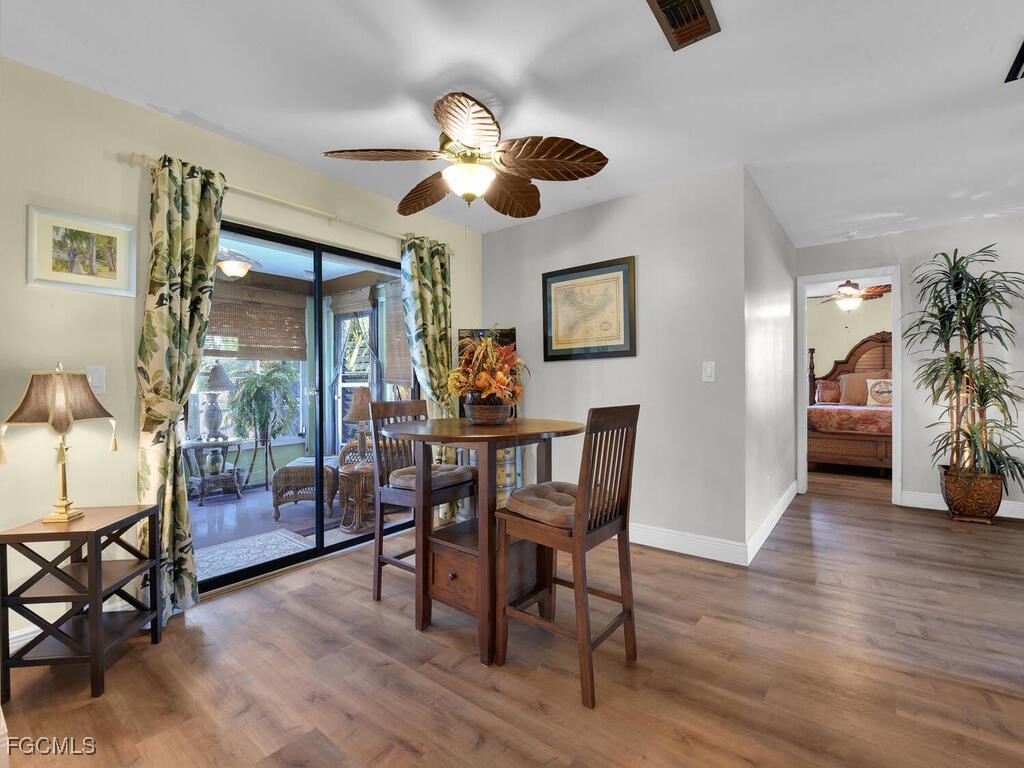 9041 Hamlin Road West Fort Myers, FL 33967 - Photo 11 of 34 a view of a dining room with furniture and wooden floor