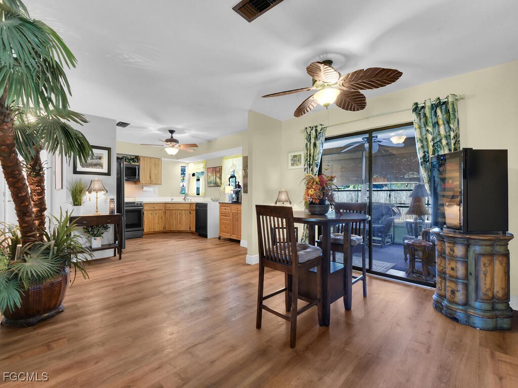 9041 Hamlin Road West Fort Myers, FL 33967 - Photo 12 of 34 a dining room with furniture and wooden floor