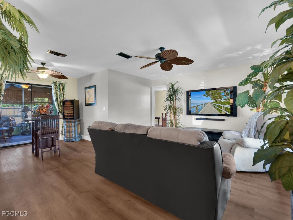 9041 Hamlin Road West Fort Myers, FL 33967 - Photo 13 of 34 a living room with furniture and a flat screen tv