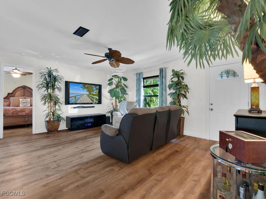9041 Hamlin Road West Fort Myers, FL 33967 - Photo 14 of 34 a living room with furniture and a flat screen tv