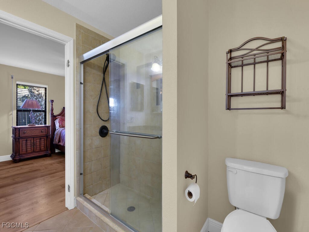 9041 Hamlin Road West Fort Myers, FL 33967 - Photo 18 of 34 a bathroom with a shower a toilet and a sink