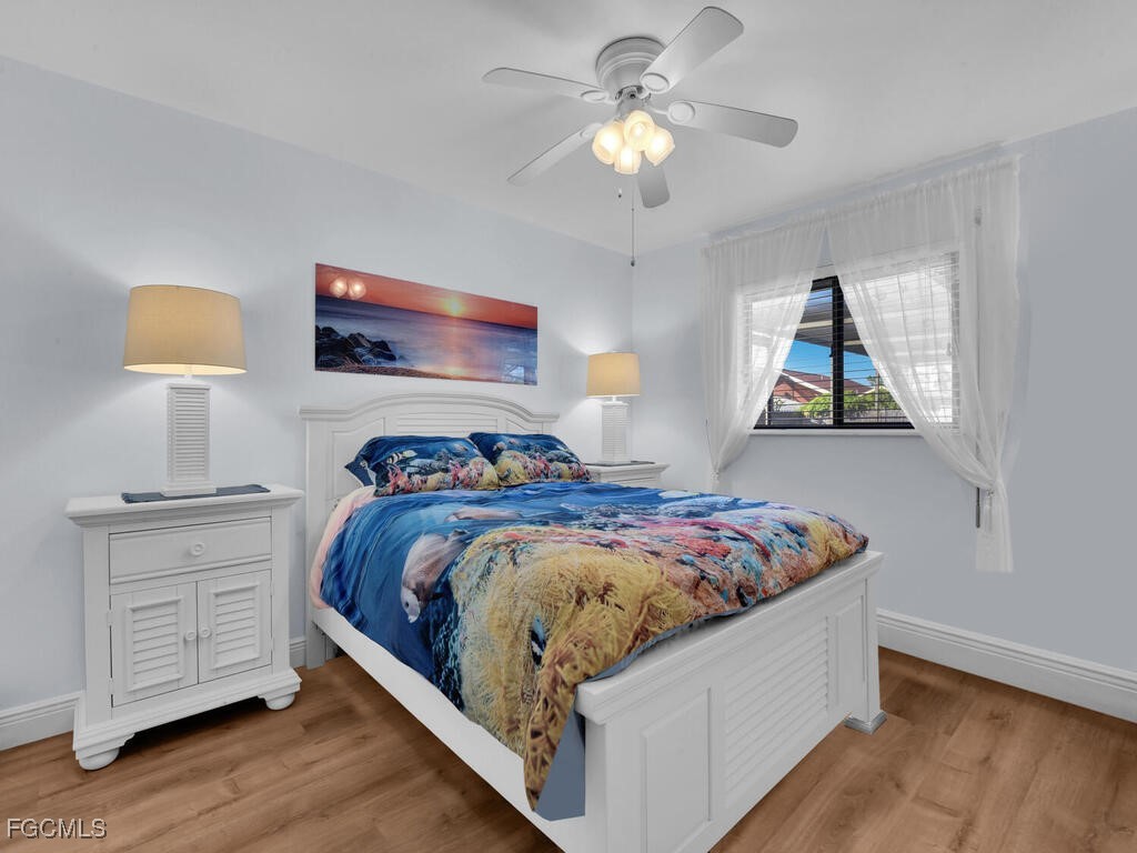 9041 Hamlin Road West Fort Myers, FL 33967 - Photo 19 of 34 a bedroom with bed and a chandelier