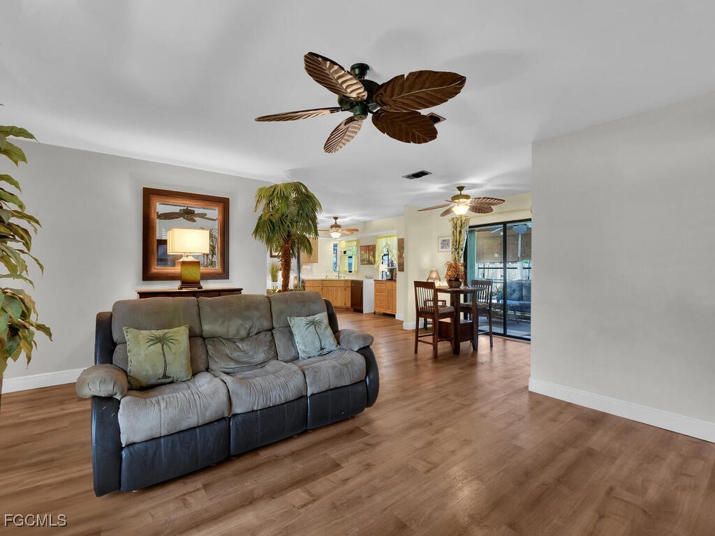 9041 Hamlin Road West Fort Myers, FL 33967 - Photo 4 of 34 a living room with furniture and wooden floor