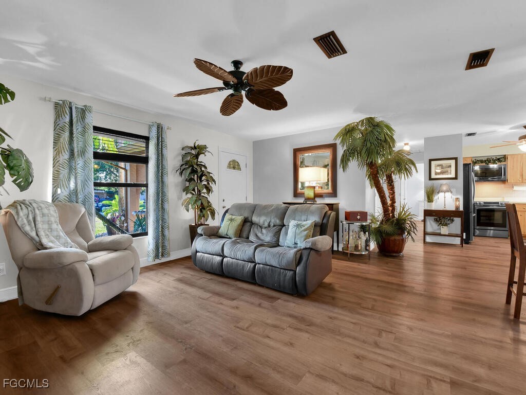 9041 Hamlin Road West Fort Myers, FL 33967 - Photo 5 of 34 a living room with furniture and a large window