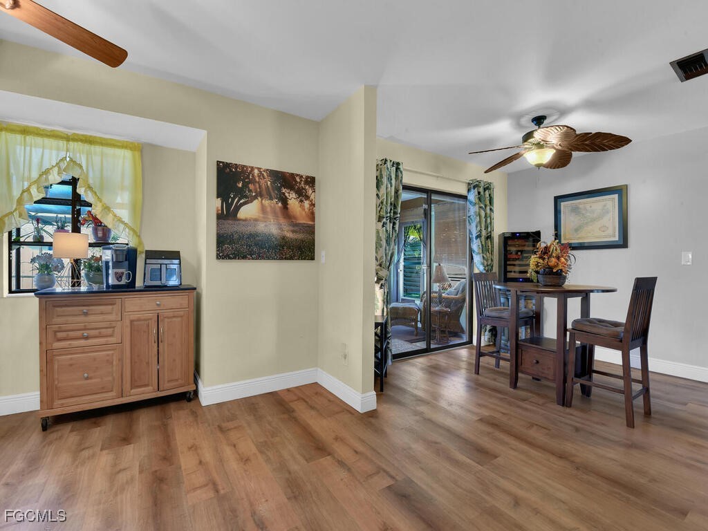 9041 Hamlin Road West Fort Myers, FL 33967 - Photo 10 of 34 a view of a dining room with furniture and wooden floor