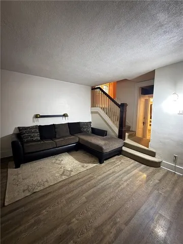 a view of a livingroom with furniture and staircase