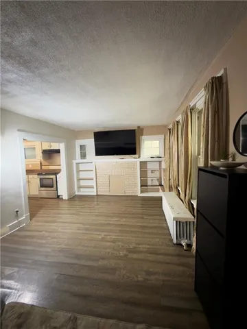 a view of a kitchen with wooden floor and electronic appliances
