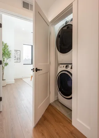 a view of a hallway with washer and dryer