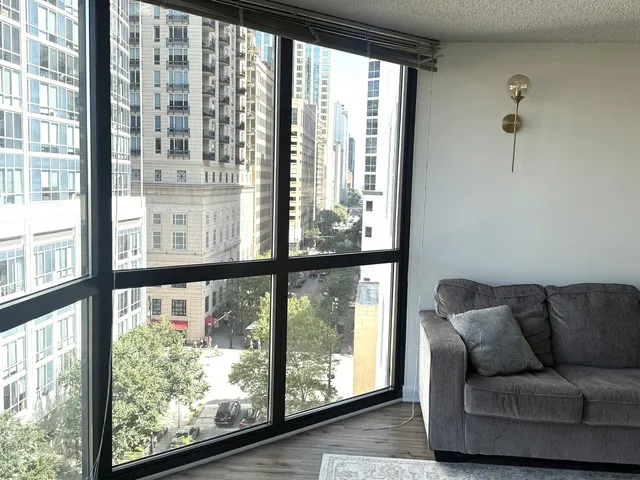 a living room filled with couches and a large window