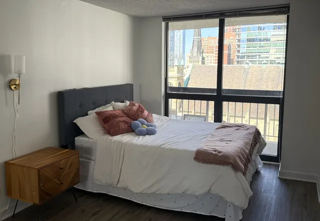 a bedroom with a bed and a window