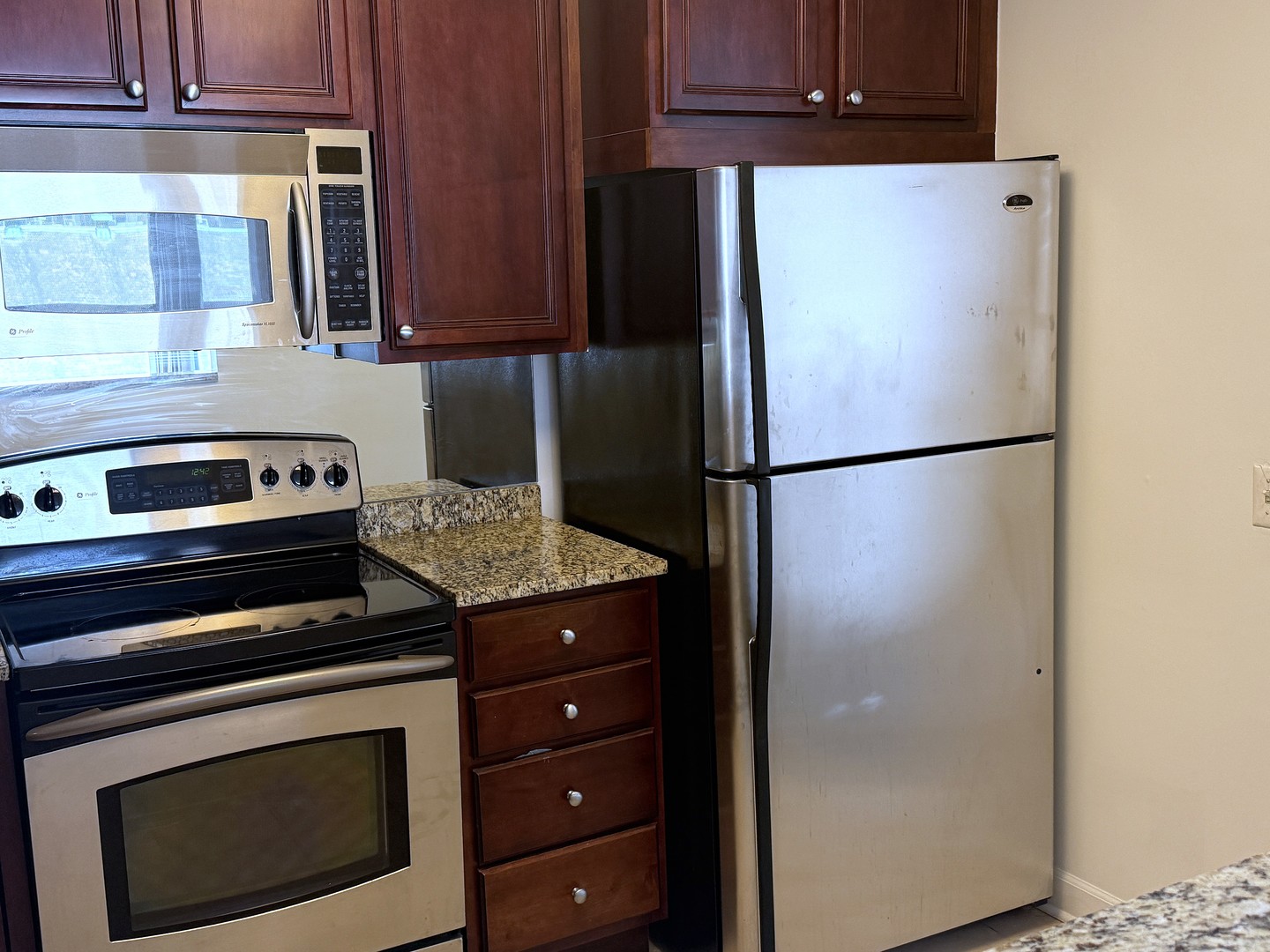 33 West Delaware Place, Unit 9D Chicago, IL 60610 - Photo 23 of 32 a kitchen with a refrigerator and cabinets