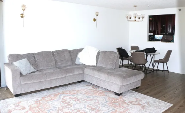 a living room with furniture and a dining table