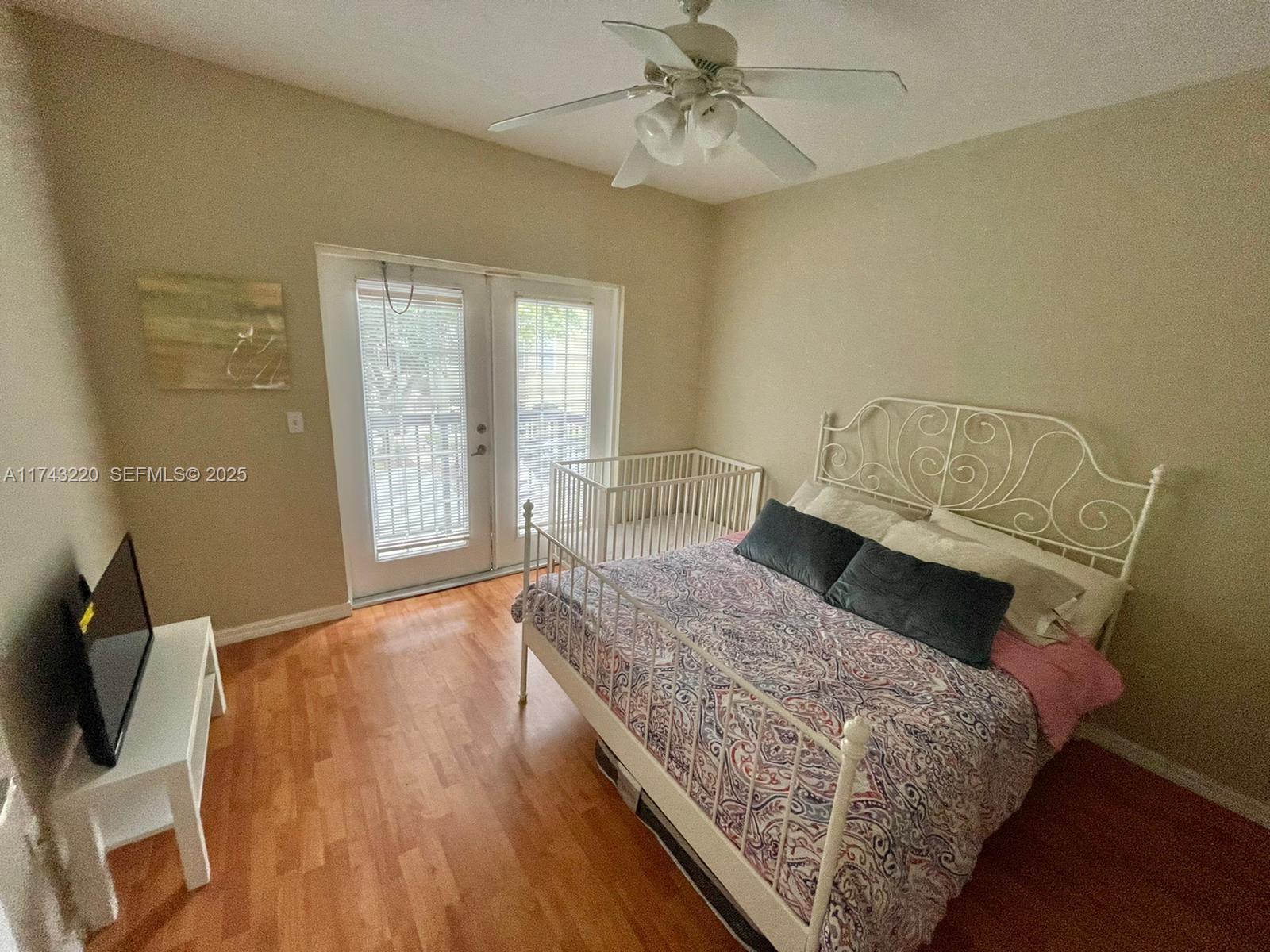 2519 Lancien Court, Unit 5 Orlando, FL 32826 - Photo 2 of 8 a bedroom with a bed and wooden floor