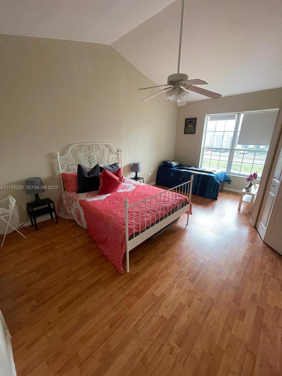 2519 Lancien Court, Unit 5 Orlando, FL 32826 - Photo 6 of 8 a bedroom with a bed and wooden floor