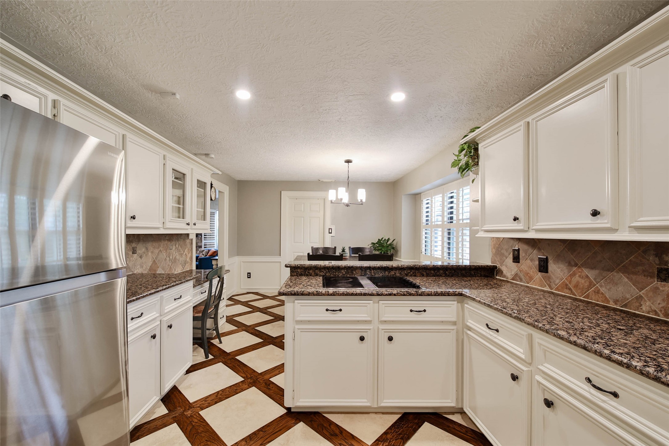 17007 Windrow Drive Spring, TX 77379 - Photo 17 of 46 a kitchen with stainless steel appliances granite countertop a stove a sink and a refrigerator