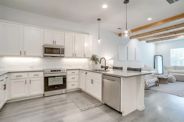a view of a house with brick walls and a yard with plants