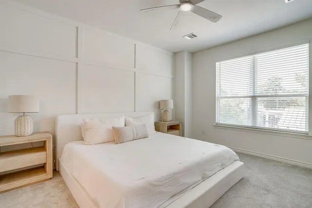 a kitchen with white cabinets and refrigerator