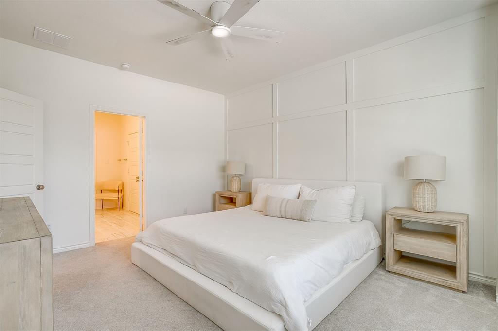 2829 Stanley Avenue Fort Worth, TX 76110 - Photo 16 of 40 a bedroom with a bed and a lamp