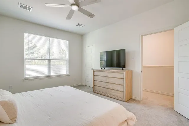 a bedroom with a bed and a lamp