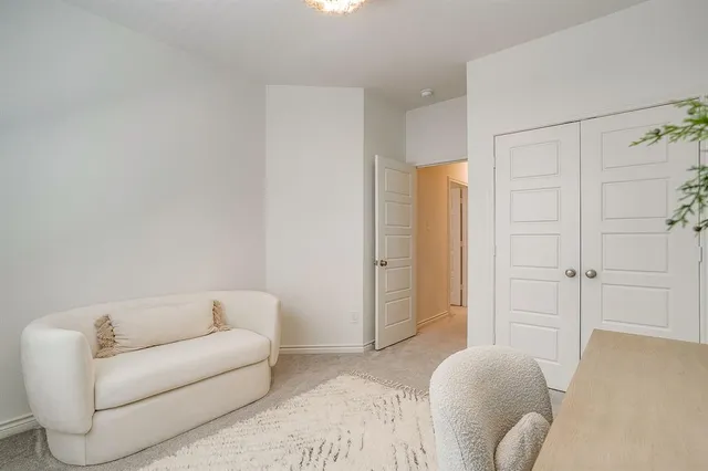 a view of a livingroom with furniture and a window