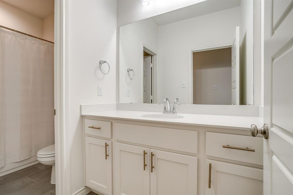 2829 Stanley Avenue Fort Worth, TX 76110 - Photo 29 of 40 a bathroom with a sink and a mirror