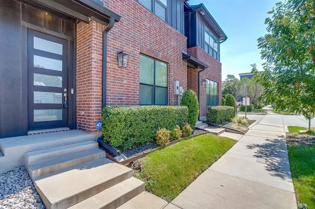 a front view of a house with a yard and plants