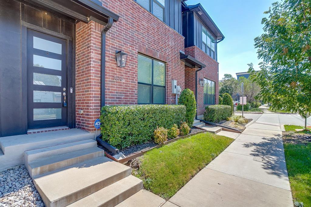 2829 Stanley Avenue Fort Worth, TX 76110 - Photo 37 of 40 a view of a house with brick walls and a yard with plants
