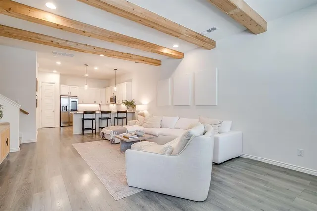 a living room with furniture and kitchen view