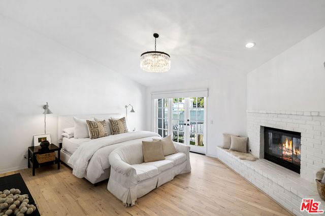 a bedroom with a bed and a fireplace