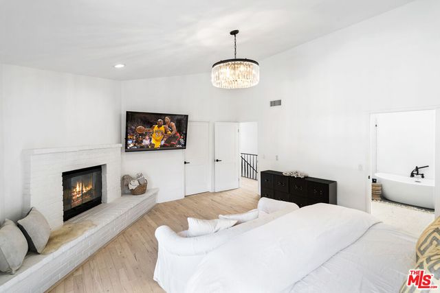 a bedroom with a bed and a fireplace