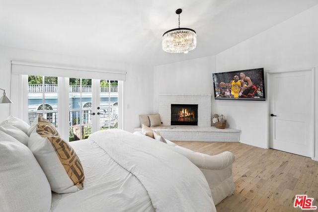 a spacious bedroom with a bed and a chandelier