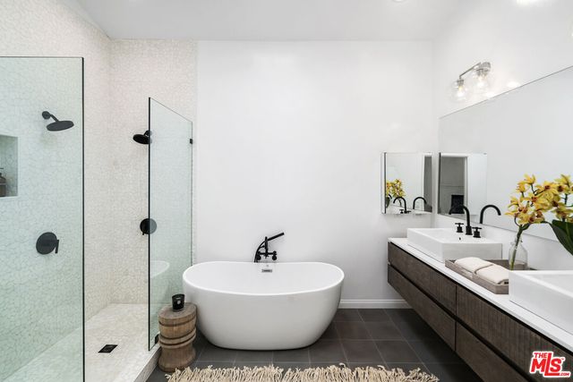 a bathroom with a double vanity sink and a bathtub